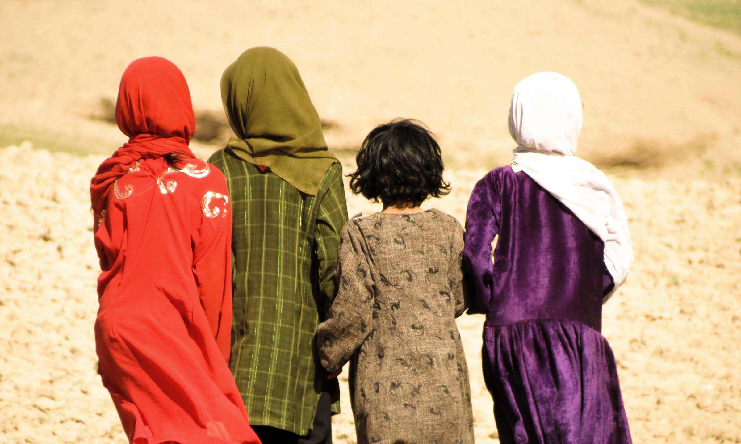 Four Afghan girls facing away from the camera