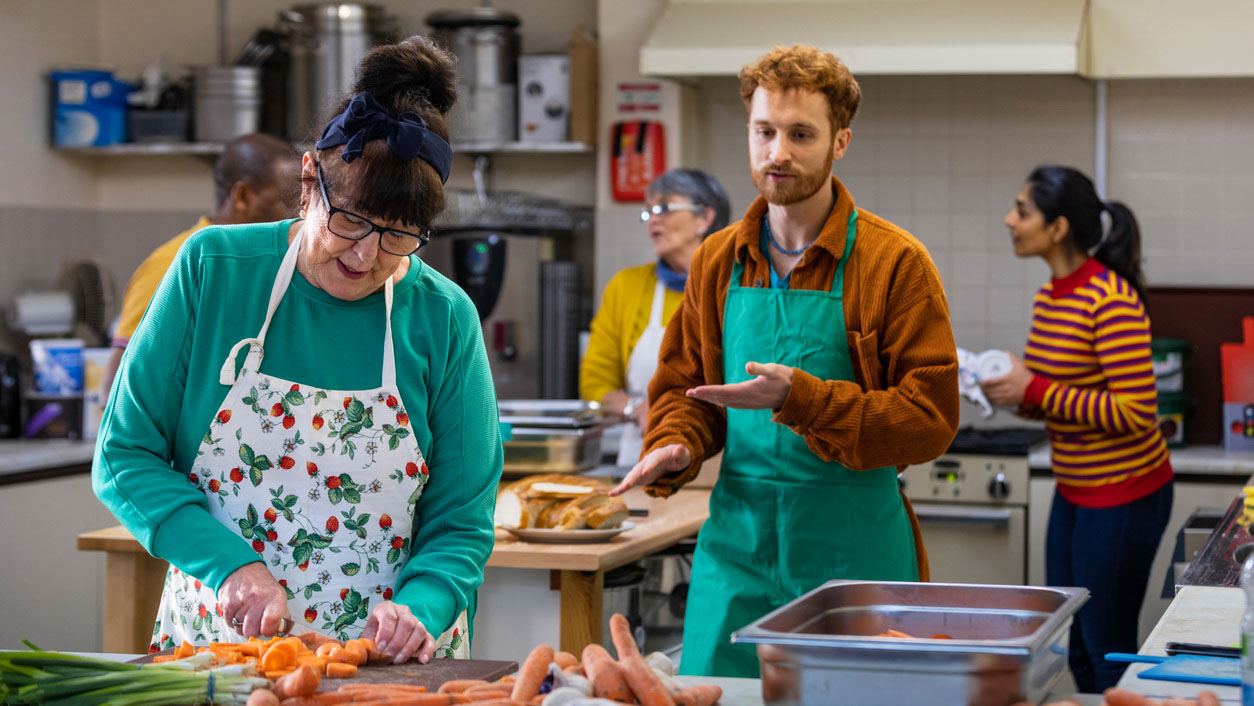 people preparing food in charity kitchen